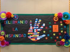 a bulletin board decorated with colorful paper flowers