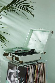 a record player sitting on top of a stack of records