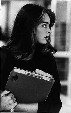 black and white photograph of a woman holding an apple folder