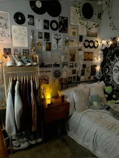 a bed room with a neatly made bed and lots of pictures on the wall