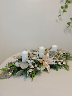 a white table topped with candles and flowers