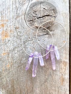 Raw purple quartz crystal points in gold or silver hoop earrings with French hooks. Perfect little boho look. Light weight and easy to wear. Add these to your boho outfits and make a 💜Healing clear quartz Crystal property has been know for centuries to restore balance in the body. -Options- 30mm as shown 21 gauge hoops Total drop Length: 2.3 inches 14k Gold filled hoops Sterling silver hoops Gold plated hoops Silver plated hoops All comes with hooks Simple, Dainty, Delicate, yet so Elegant and Festival Hand Wrapped Dangle Jewelry, Festival Hand-wrapped Dangle Jewelry, Nickel-free Purple Dangle Hoop Earrings, Purple Nickel-free Dangle Hoop Earrings, Purple Bohemian Everyday Jewelry, Purple Dangle Hoop Earrings With Ear Wire, Bohemian Wire Wrapped Hoop Crystal Earrings, Bohemian Wire Wrapped Hoop Jewelry, Minimalist Purple Drop Earrings