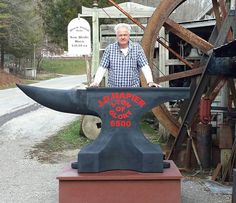 an old man standing next to a large bull horn