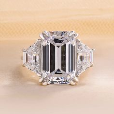 an emerald cut diamond ring with three baguets