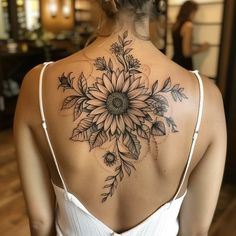 a woman with a sunflower tattoo on her back