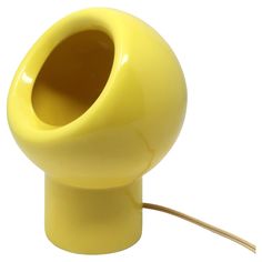 a yellow lamp with a cord attached to it's end on a white background