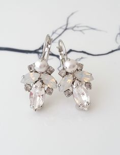 "✤ I can make these earrings with many available other colors to match your wedding party scheme (or any available other occasion). Please just contact me. ✤ Matching bracelet is available here (you can choose silver at the metal drop-down menu): http://etsy.me/2i515sF ✤ Made with premium quality genuine European crystals. ✤ Drop/lever back Earrings. Clip-on earrings are available upon request. ✤ Size of elements approx - 25 x 18 mm. Length 35 mm(including hook) ✤ Colors: White pearl, white opal Bridal Earrings Silver, Pearl Bridal Earrings, Bridal Earrings Studs, Silver Bridal Earrings, Emerald Earrings Drop, White Opal Earrings, Silver Bridesmaid, Geode Jewelry, Petite Earrings