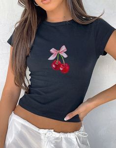 Introducing our Cherry Bow Art Baby Tee, a trendy blend of coquette aesthetic cherry-inspired style. Made from 100% premium cotton, this tee offers a luxuriously soft feel and a 90's/Y2K fit that ensures comfort all day long. Designed with a high-quality print, the Cherry Bow Baby Tee showcases a captivating bow motif and juicy cherries that adds a touch of girly elegance to any outfit. Our Baby Tee is crafted using the Gildan 5000b, a youth-sized shirt designed to authentically emulate the classic 90s/Y2K Baby Tee look. Whether paired casually with jeans or dressed up with a skirt, this tee seamlessly integrates into any wardrobe, making it an ideal choice for gifting. Embrace the allure of the coquette aesthetic with our thoughtfully crafted tee, where comfort meets fashion in every deta Fitted Sweet Top With Graphic Print, Sweet Fitted Cotton T-shirt, Fitted Casual Tops With Cherry Print, Fitted Casual Cherry Print Tops, Y2k Style Cotton Tops With Cherry Print, Fitted Cotton T-shirt With Cherry Print, Sweet Cotton Summer Top, Fitted Fruit Print Tops For Spring, Sweet Red Summer Tops