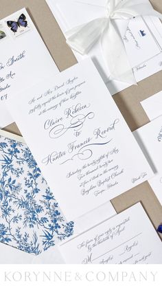 the wedding stationery is laid out on top of each other