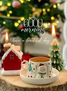 a coffee cup and saucer sitting on top of a wooden table next to a christmas tree