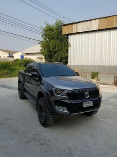 a black pick up truck parked in front of a building