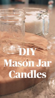 two mason jars sitting on top of a wooden cutting board