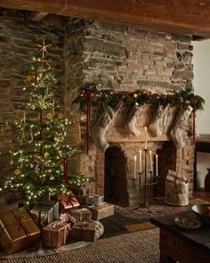 a living room with a christmas tree and fireplace