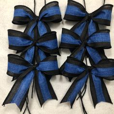 several blue and black bows are arranged together