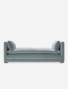 a gray couch with two pillows on it