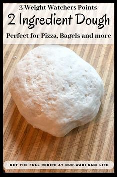 a ball of dough sitting on top of a wooden cutting board