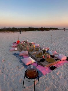 a picnic on the beach is set up with food and drinks