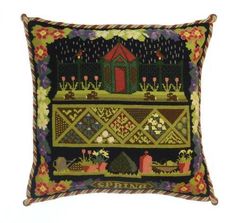 a decorative pillow with an image of a house on the top and flowers in the bottom