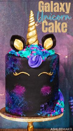 there is a black cake with purple and blue frosting