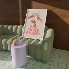 there is a poster on the wall next to a couch with a cup in it