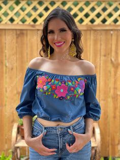 This Beautiful Off the Shoulder Crop Top is the perfect Top for a fun day out. It's made out of fine, soft denim and has elastic around the waist. The floral design is hand embroidered. This blouse is hand embroidered and the embroidered colors vary on each blouse making each blouse one of a kind. More colors available here: https://www.etsy.com/es/listing/855531148/crop-top-manga-larga-blusa-artesanal?ref=listings_manager_grid Purchase the Artisanal Mexican earrings modeled here: https://www.et Cute Embroidered Tops For Vacation, Cute Multicolor Embroidered Tops For Spring, Floral Embroidered Tops For Spring Festival, Cute Multicolor Embroidery Tops For Spring, Cute Floral Embroidery Summer Tops, Cute Embroidered Summer Tops, Cute Embroidered Beach Tops, Cute Embroidered Tops For Spring, Cute Embroidered Spring Tops