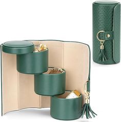 a green case with three compartments and a tassell in the bottom one is open