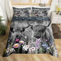 a bed with two cows and flowers on it