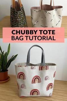 three tote bags sitting on top of a wooden table next to a potted plant