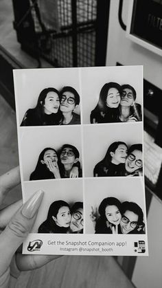 black and white photograph of people taking selfies with polaroid frames in their hands