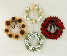 four crocheted wreaths hanging on the wall