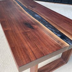 a close up of a wooden table with water running down the side and on top