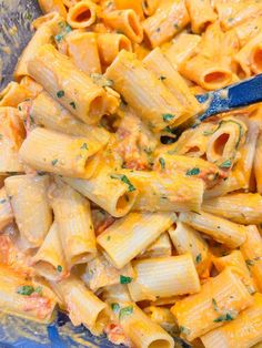 a blue bowl filled with macaroni and cheese