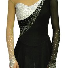 a woman wearing a black and white dress with silver sequins on the shoulder