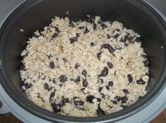 a pot filled with rice and raisins on top of a stove