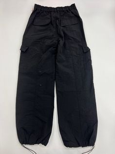 100% Nylon Loose Fit Pants Oversized Pockets on both legs Adjustable toggles at hem Streetwear Nylon Pants With Belt Loops, Nylon Parachute Pants With Belt Loops For Streetwear, Nylon Hiking Bottoms With Cargo Pockets, Sporty Nylon Cargo Pants With Belt Loops, Nylon Wide Leg Bottoms For Outdoor Activities, Nylon Bottoms With Pockets For Outdoor, Nylon Parachute Pants With Belt Loops For Outdoor Activities, Outdoor Wide Leg Nylon Pants, Wide Leg Parachute Pants With Belt Loops For Outdoor