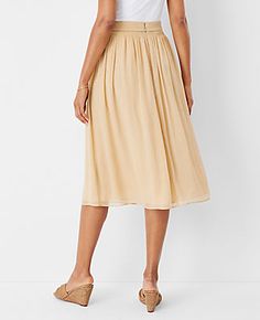 Elevate your wardrobe with the Ann Taylor Metallic Dobby Stripe Shirred Waist Midi Skirt. This skirt combines effortless elegance with a touch of shimmer, perfect for any occasion. 

- Size: 10 (Regular)
- Color: Toasted Oat
- Material: 100% Polyester
- Length: 30 inches long
- Features: Elasticized waist, fully lined
- Care: Machine washable

Designed for the modern woman, this skirt's shirred waist and flowing silhouette ensure both comfort and style. The subtle metallic stripes add a chic, ey Beige Knee-length Gathered Skirt Bottoms, Non-stretch Cotton Tiered Skirt, Beige Non-stretch Tiered Skirt, Relaxed Fit Midi-length Gathered Skirt, Relaxed Midi-length Pleated Skirt With Elastic Waistband, Knitted Suit, Effortless Elegance, Ann Taylor, Modern Woman