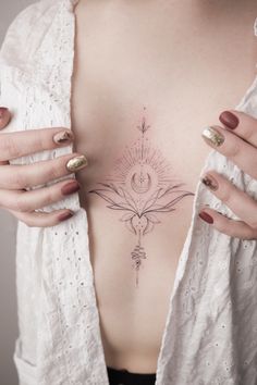 a woman's chest with tattoos on it and her hands holding onto the back