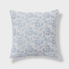 a blue and white pillow on a gray background