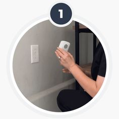 a woman sitting on the floor with a remote control in her hand, and an image of a light switch