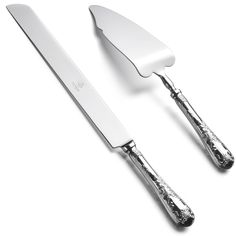 two knives and a fork on a white surface