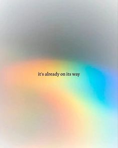 the words it's already on its way are shown in an abstract rainbow - hued background