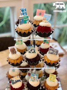 cupcakes are stacked on top of each other and decorated with different types of books