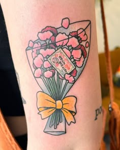 a woman's arm with a bouquet of flowers on it