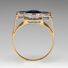 This stunning circa 1930s antique ring features a semi-bezel set, round cut center sapphire, two baguette cut side sapphires, and 18 bead set, round single cut accent diamonds. The ring measures 11.4mm at the top, rises 5.5mm above the finger, tapering to 2.0mm wide and 0.8mm thick at the base of the shank. The ring is currently a size 7. The sapphires show gentle abrasion and the ring overall is in great shape. Collectible Art Deco Sapphire Ring, Art Deco Sapphire Ring With 17 Jewels, Vintage Sapphire Diamond Ring With Rose Cut, Vintage Sapphire Cluster Ring With Oval Shape, Art Deco Sapphire Ring For Anniversary, Art Deco Sapphire Anniversary Ring, Antique Sapphire Ring With 17 Jewels, Vintage Sapphire Ring With Polished Finish For Wedding, Vintage Sapphire Cluster Ring With Gemstones