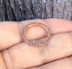 Full Eternity Band Ring with Natural Pink Sapphires. Material: Solid Gold (14K or 18K) Finishing: High Polished/ Shiny Fit: Standard Width: 1.8mm Height: 2mm Setting: U Micro Pave Set Stone: Natural Pink Sapphire Precious Stone Shape & Cut: Round, Diamond Cut Quality: AAA Quantity of Stones: apx 40 (varies by size) Total Carat Weight: 0.80 ct (varies by size) This Ring is Full of Elegance and Beauty! It is so Simple and so Complete at the same time! One can wear this band alone by itself or Pink Sapphire Stackable Ring For Wedding, Stackable Pink Sapphire Wedding Ring, Stackable Pink Sapphire Ring For Wedding, Pink Sapphire Halo Jewelry With Round Cut, Rose Gold Ruby Ring With Halo, Pink Sapphire Eternity Band For Anniversary Fine Jewelry, Pink Sapphire Eternity Band With Prong Setting For Anniversary, Anniversary Pink Sapphire Eternity Band With Prong Setting, Anniversary Pink Sapphire Halo Ring