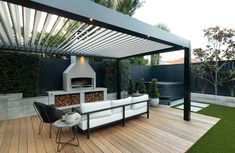 an outdoor living area with wood flooring and white furniture