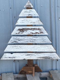 a wooden christmas tree sitting on top of pallets