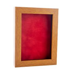 an empty wooden frame with red velvet in the bottom and bottom corner, on a white background