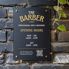 the barber shop opening hours sign on a brick wall next to a potted plant