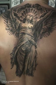 the back of a man with an angel tattoo